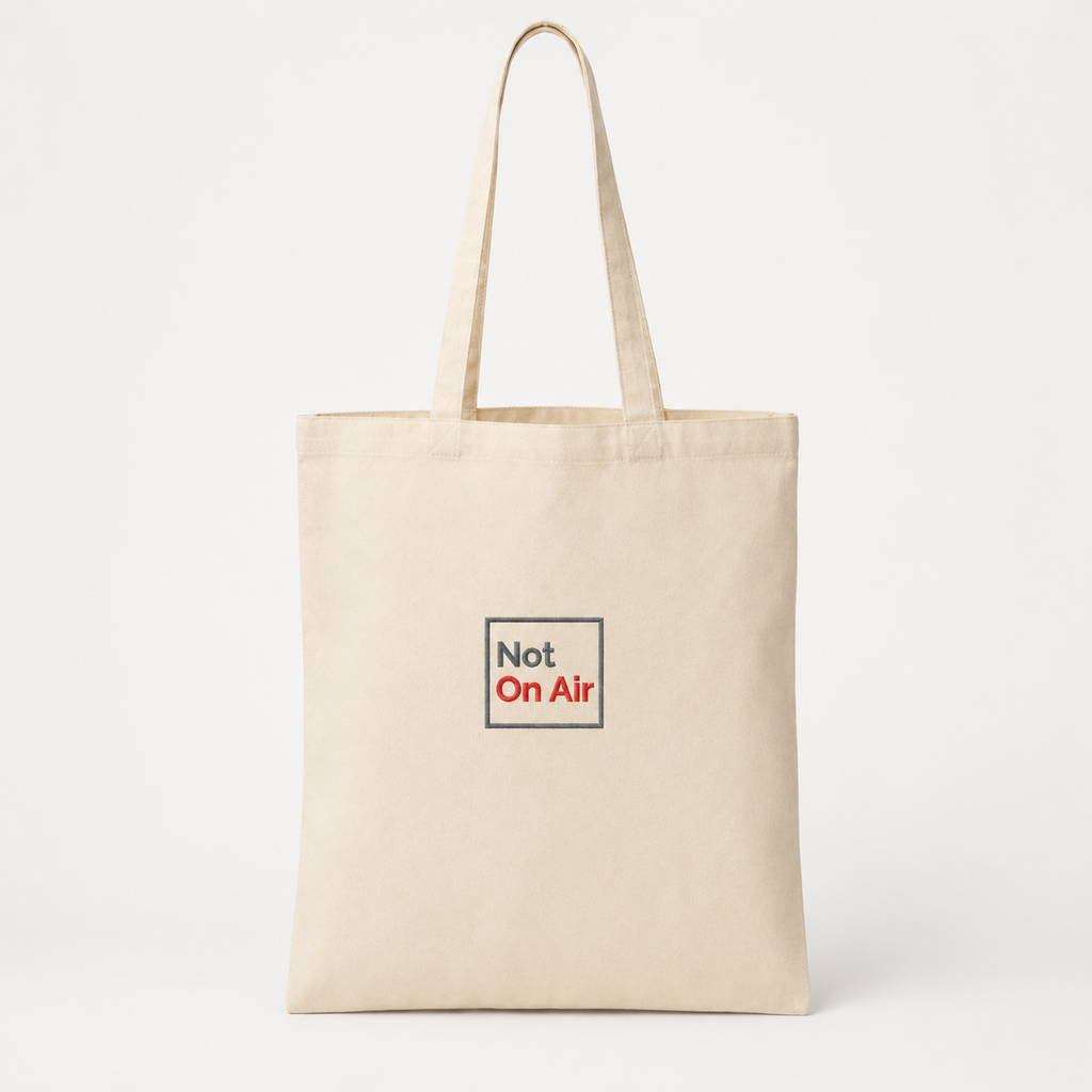 Natural canvas Not On Air tote bag with a smaller dark gray and red embroidered logo centered on the front.